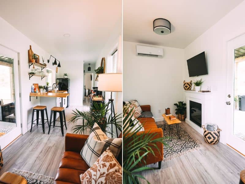 Interior view of Nova Cottage showing the open plan living space with a leather sofa and small but well-equipped kitchen area.